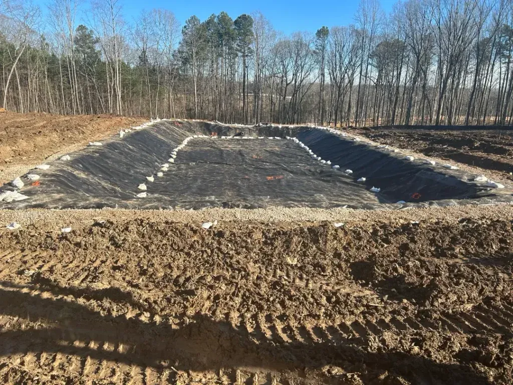 Large foundation construction site in forested area