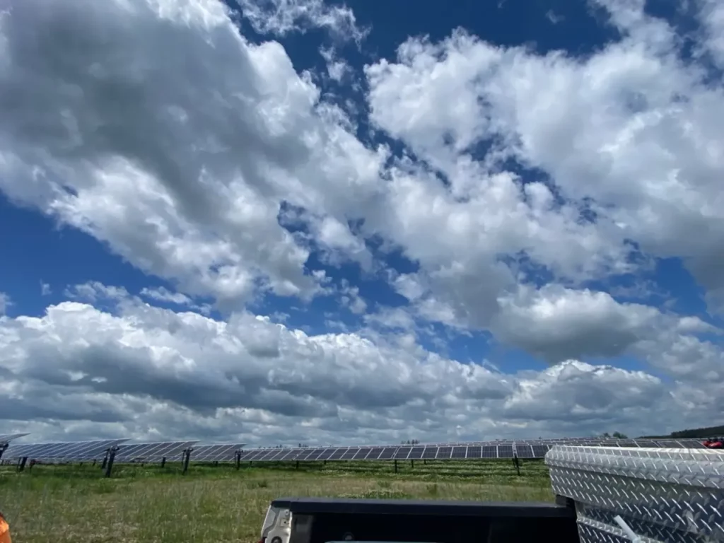 Solar panels under partly cloudy sky