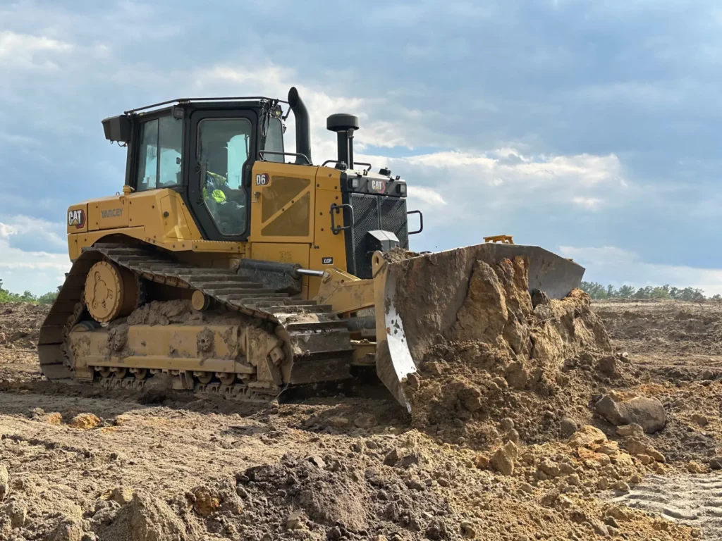 Yellow bulldozer working on a muddy construction site
