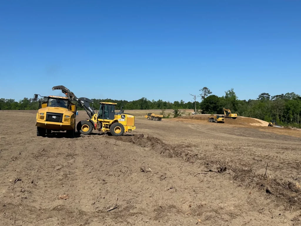 Heavy machinery operating in a cleared field