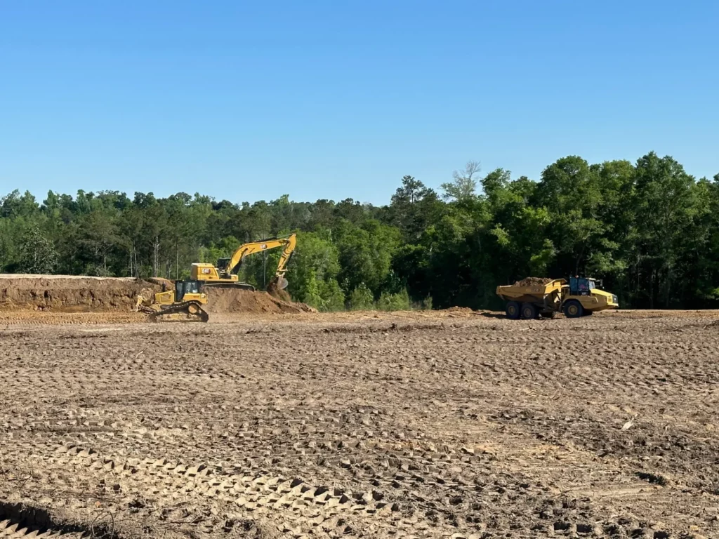 Excavator and dump truck at construction site