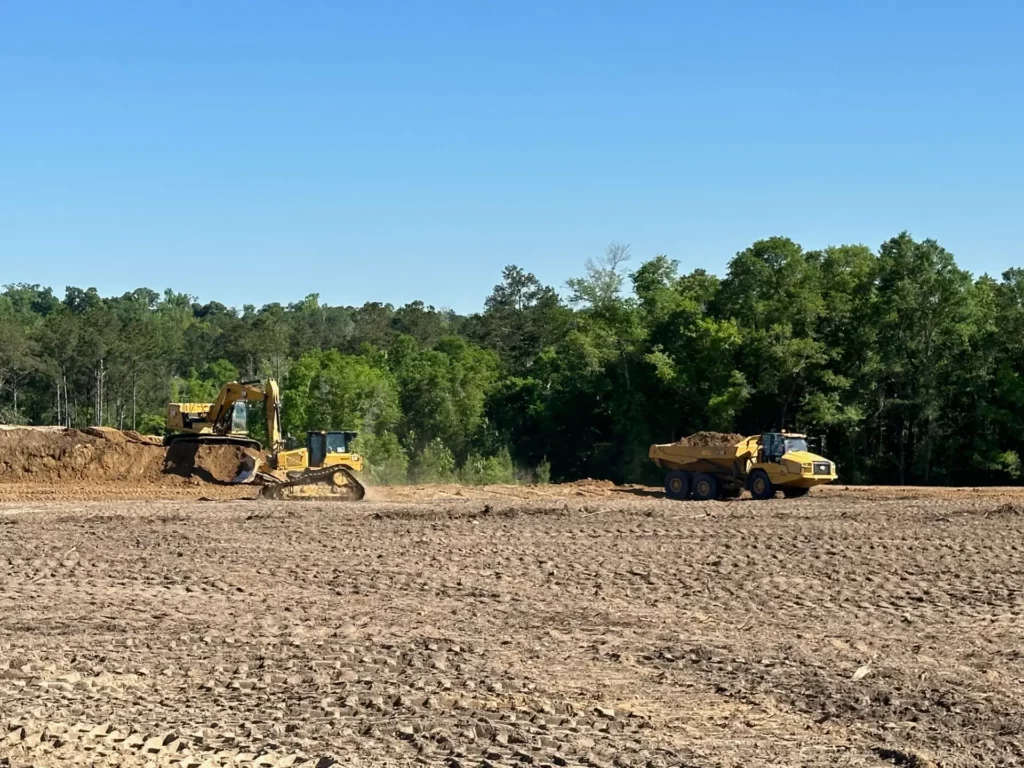 Excavator and dump truck at a construction site