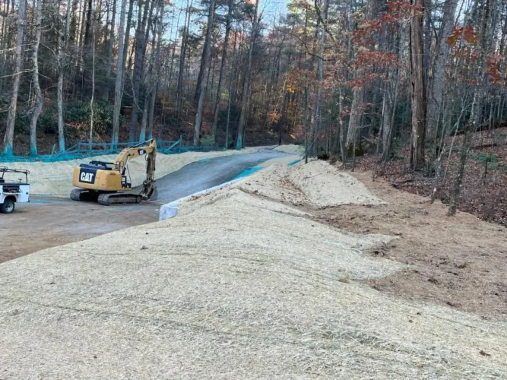 Excavator on new road construction site in forest