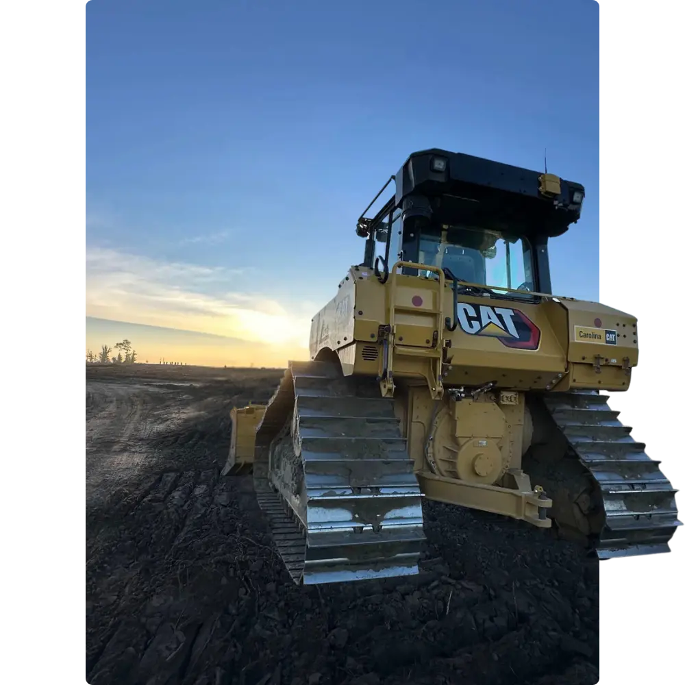 CAT bulldozer on dirt at sunset