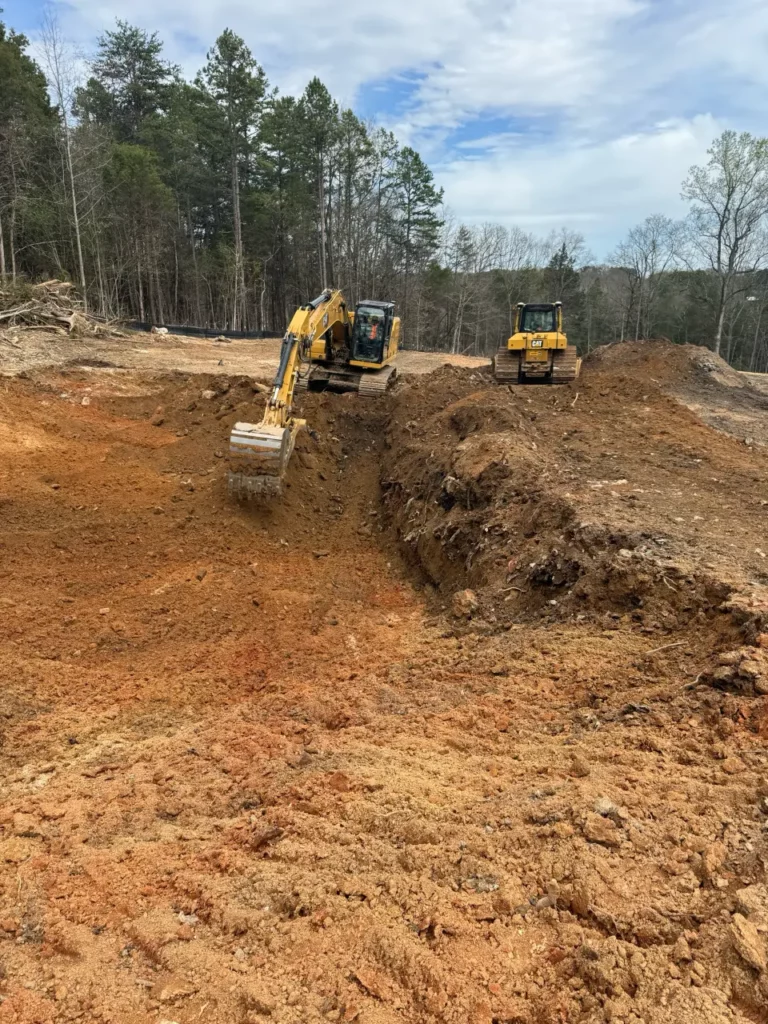 Yellow excavators working on forest land development