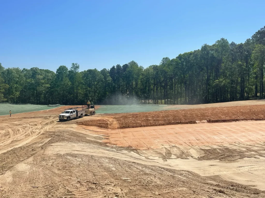 Truck and workers at a sunny construction site