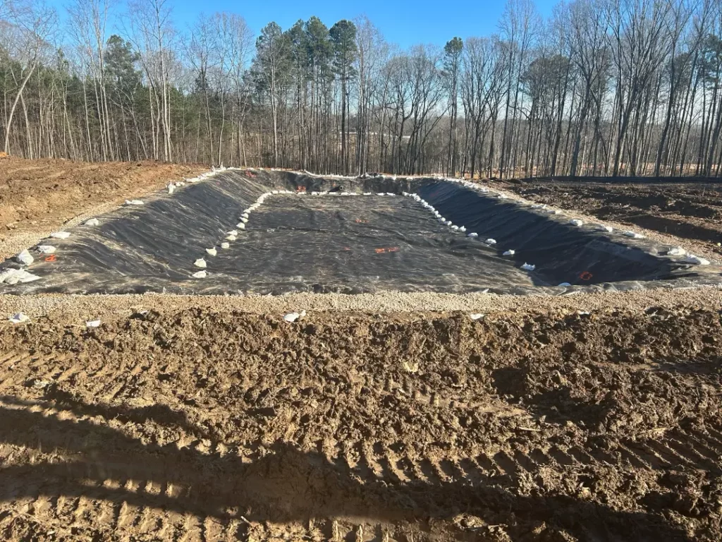 Large foundation construction site in forested area